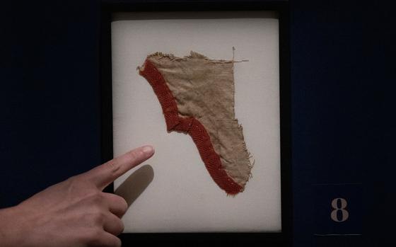 Museum staff member Beth Ann Downey points at a fragment of a George Washington's tent displayed on Wednesday, July 10, 2024, at the Museum of the American Revolution in Philadelphia. A Virginia man bought for auction from Goodwill for $1,300. (Jose F. Moreno/The Philadelphia Inquirer/TNS)