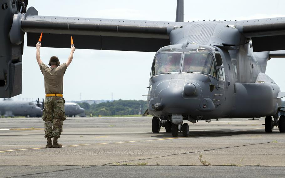 An Air Force crew chief assigned to the 21st Special Operations Aircraft Maintenance Squadron marshals a CV-22B Osprey at Yokota Air Base, Japan, July 2, 2024. 