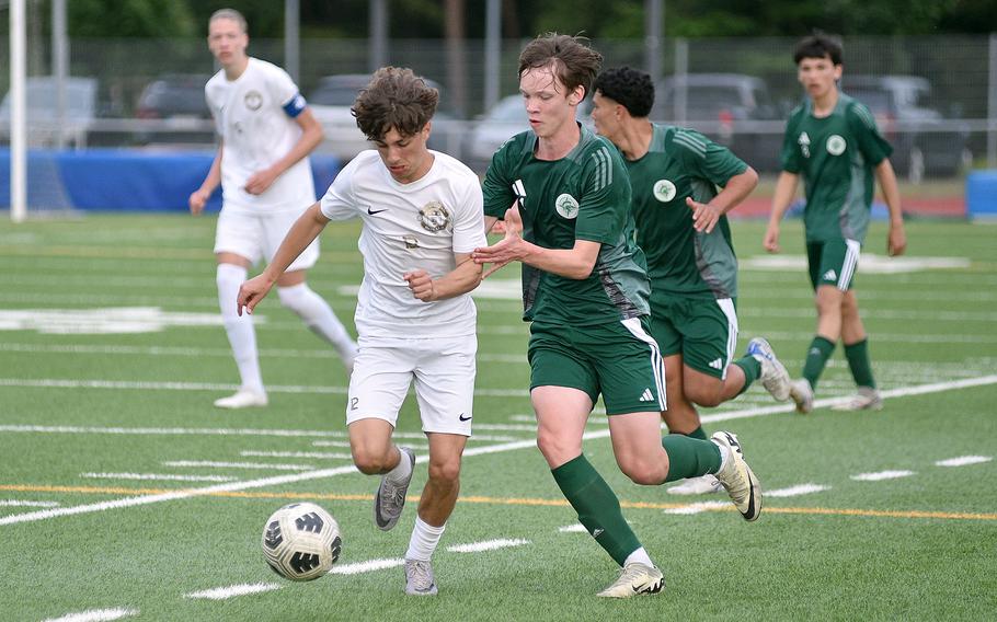 SHAPE right back Tymon Kaminski holds onto Ramstein left winger Keiran Goodall during the Division I final of the DODEA European championships on May 23, 2024, at Ramstein High School on Ramstein Air Base, Germany.