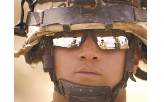 Tahweelah, Iraq, Feb. 19, 2009: Reflected in the glasses of an Iraqi soldier, 1st Lt. Javier Avila, 3rd Platoon leader for Company A, Task Force 3-66 Armor, and Lt. Zafer from the Iraqi army, coordinate a patrol in the village of Tahweela, Iraq. The operation aims to bring the "clear, hold and build" strategy to the southern Balad-Ruz District of Iraq's Diyala province. 

Read the 2009 article on Task Force 3-66's operations and see additional photos here. 

META TAGS: Operation Iraqi Freedom; U.S. Army; Operation Dark Wolf Pursuit One; Task Force 3-66 Armor; Diyala province; Iraqi army; Sunni insurgents; 