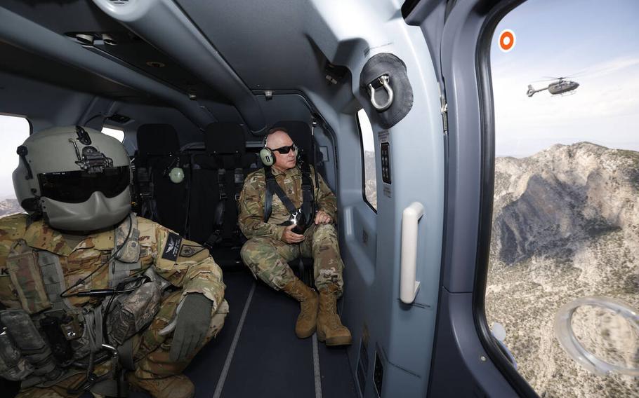 U.S. Army National Guard Sgt. Michael Knight, left, and Sgt. 1st Class Erick Studenicka, ride a UH-72B Lakota helicopter, Tuesday, May 16, 2023, around the Red Rock Canyon area, as another UH-72B Lakota helicopter following it, right.  