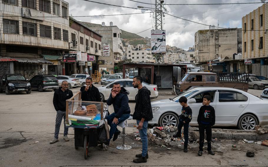 A vendor sells fried dough near an entrance to the Balata refugee camp on the outskirts of Nablus.