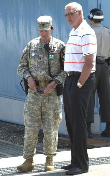 Basketball legend Jerry West talks with a United Nations Military Armistice Commission escort during a visit Thursday to the Joint Security Area of Korea’s Demilitarized Zone. West, whose brother David was killed in the Korean War, said his visit to South Korea was probably the highlight of his life.                               