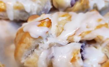 Close-up of Blueberry almond danish drizzled with white frosting