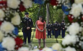 U.S. service members and civilians bow their heads during the invocation at the Bronze Cross Statue Memorial Wreath Laying Ceremony at Joint Base Langley-Eustis, Va., May 20, 2017. The ceremony paid tribute to all the Gold Star families who attended and provided them with a Gold Star lapel pin.