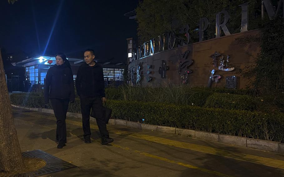 Plainclothes police officers pass by a primary school 