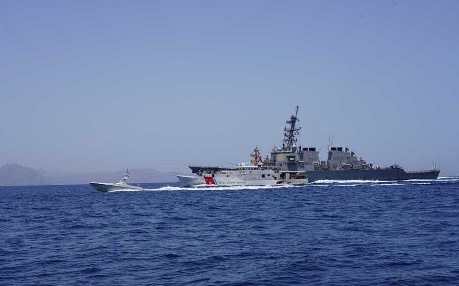 An unmanned surface vessel sails in front of U.S. Coast Guard fast response cutter USCGC Clarence Sutphin Jr. and U.S. Navy destroyer USS Paul Hamilton during a Strait of Hormuz transit May 23, 2023.