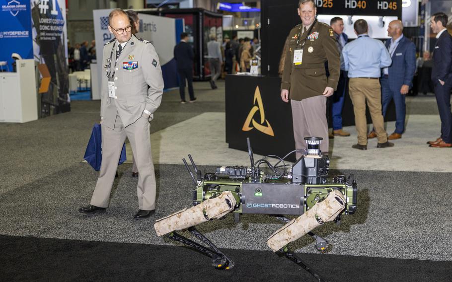 Members of the military check out a Ghost Robotics robot