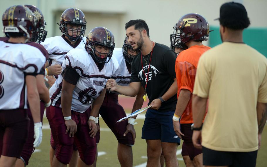 Daniel Burns, middle, is in his second season as Matthew C. Perry football head coach, after three years as offensive coordinator. Burns was a 2008 graduate of Seoul American High School and played football for the Falcons, who won Far East Division I titles in 2006 and 2008.