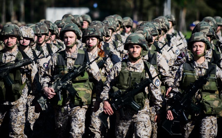 Latvian service members march into formation in preparation for the opening ceremonies of Saber Strike 15 June 8, 2015, at Adazi Training Area, Latvia. 