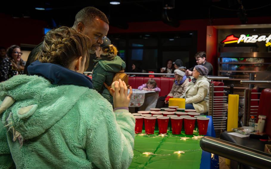 Children and their parents play games at the Spangdahlem Christmas party.