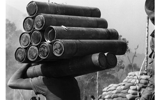 Fire Support Base 25 - Dak To Bo, South Vietnam, Mar. 11, 1968: A soldier carries spent Howitzer shells. The artillery piece at Fire Support Base 25 overlooking the Cambodian border of Vietnam is one of many hill-top FSBs around Dak To. 

Looking for Stars and Stripes’ coverage of the Vietnam War? Subscribe to Stars and Stripes’ historic newspaper archive! We have digitized our 1948-1999 European and Pacific editions, as well as several of our WWII editions and made them available online through https://starsandstripes.newspaperarchive.com/

META DATA: Vietnam war; combat; U.S. Army; Infantry; servicemen; soldier; combat; artillery; cannon;