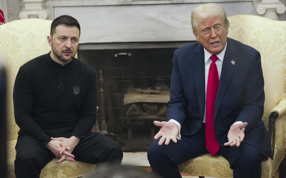 Donald Trump and Volodymyr Zelenskyy sit next to each other in yellow chairs in front of a fireplace in the Oval Office of the White House.