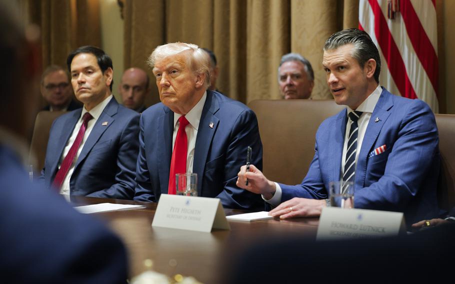 President Donald Trump listens during a meeting.