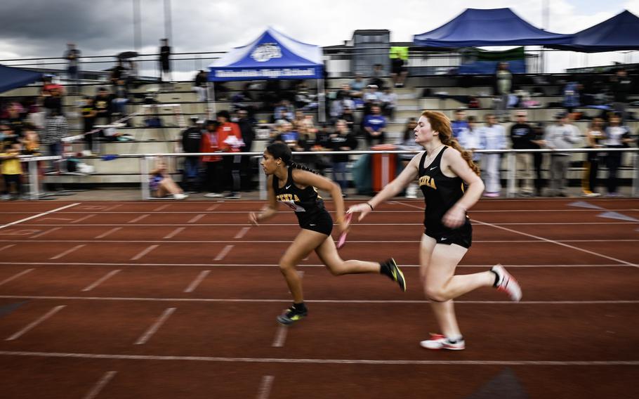 Vicenza teammates exchange the baton during the girls 4x400 meter relay at the 2024 DODEA European Championships at Kaiserslautern High School in Kaiserslautern, Germany, on May 24, 2024. Vicenza finished last with a time of 4:34.36.