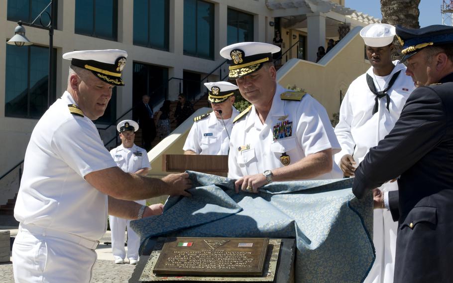 Rear Adm. David Mercer is joined by Capt. Thomas Quinn and Italian air force Col. Luca Tonello in the unveiling of a plaque to commemorate 50 years of partnership between the U.S and Italy on June 12, 2009, at Naval Air Station Sigonella in Sicily. The base began operations in 1959 as a support hub for aircraft transiting through the Mediterranean Sea area.