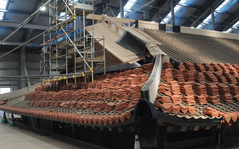 Tiles made of mudstone and red clay are placed on the roof of Shuri Castle's main hall in Naha, Okinawa, on July 15, 2024.