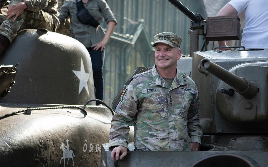 Army Gen. Christopher Cavoli rides a tank into Mons, Belgium