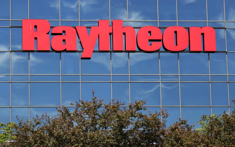 The sky is reflected on the facade of Raytheon’s Integrated Defense Systems facility, June 10, 2019, in Woburn, Mass.