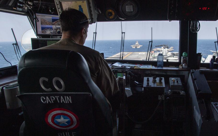 A view out the window of the command center as a fighter jet takes off.