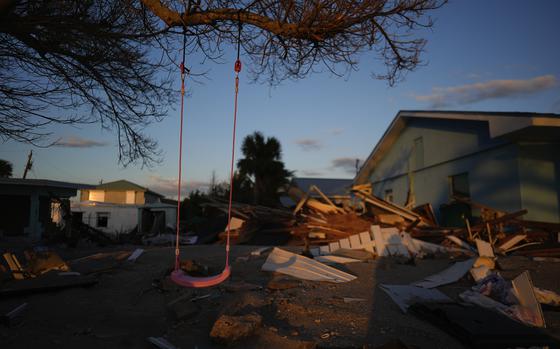 A child’s swing still hangs on a tree in Manasota Key in Florida after Hurricane Milton left destruction in its wake.