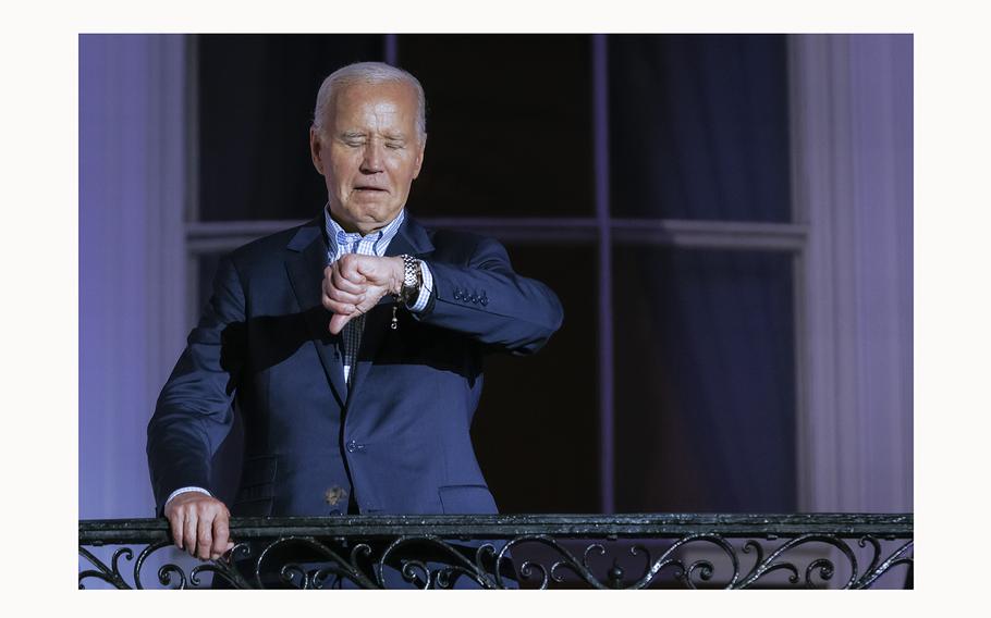 President Joe Biden checks his watch as he steps out onto the balcony of the White House to view the fireworks over the National Mall during a 4th of July event on the South Lawn of the White House on July 4, 2024 in Washington, DC. 