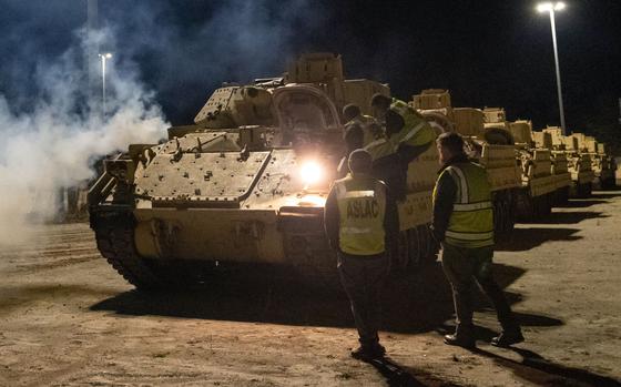 Drivers load Bradley Fighting Vehicles onto a ship in North Charleston ...