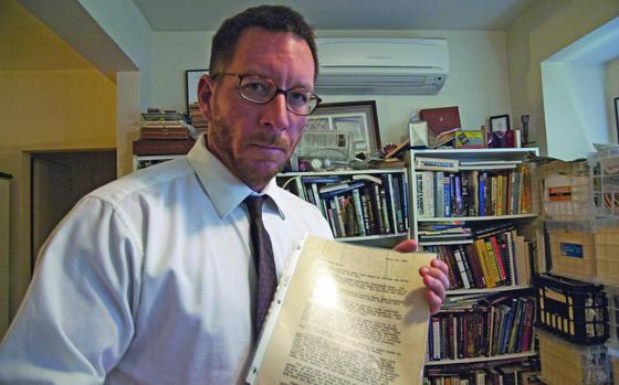 Andrew Carroll, founder of the Legacy Project, poses with a letter written by a U.S. servicemember in April 21, 1945 that helped inspire the effort to start collecting letters written by troops during the nation's connflicts. The servicemember was a distant cousin of Carroll's. 