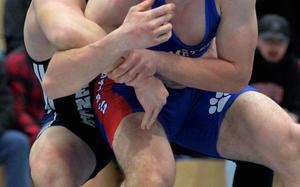 Wrestlers square off on the mat.