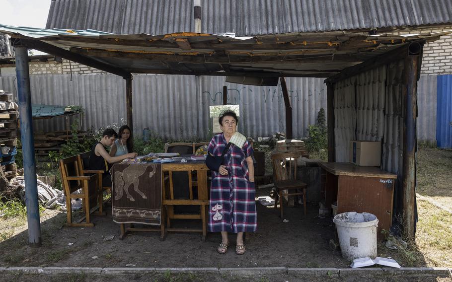 Valentina Bezruk waits as her grandson, Anton, meets with psychologist Alina Davydenko, who travels to Kupyansk to work with families traumatized by the war.