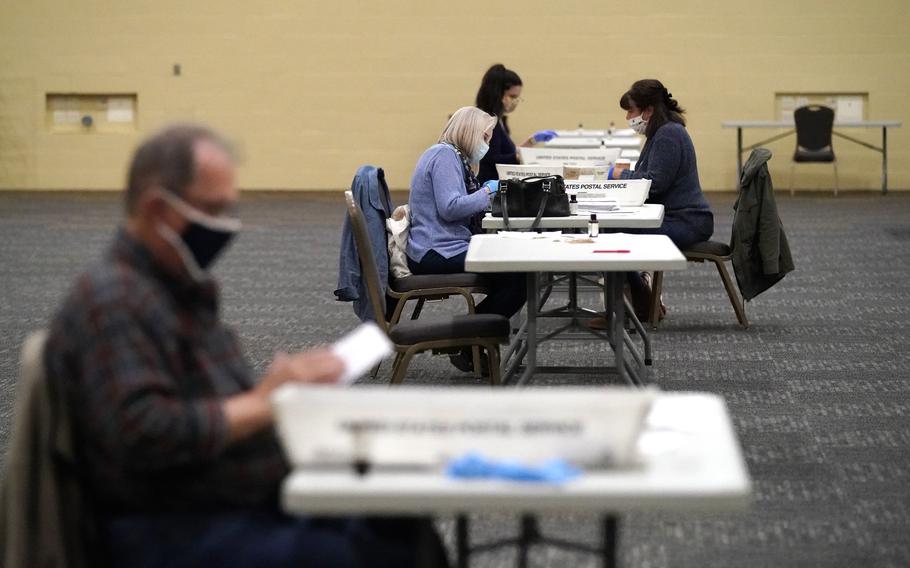 Election workers in Lancaster, Pa. prepare mail-in ballots, Nov. 4, 2020.