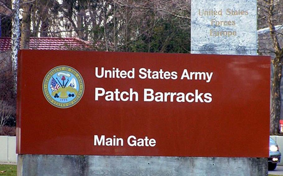 A sign reading, “United States Army Patch Barracks Main Gate” with a placard attached at the top right corners saying, “Headquarters United States Forces Europe” is shown in an undated photo.  