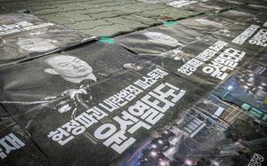 Banners outside the National Assembly building call for the ouster of South Korean President Yoon Suk Yeol, Dec. 5, 2024. 
