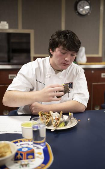 Chef Hayden Florence, tastes and judges a taco 