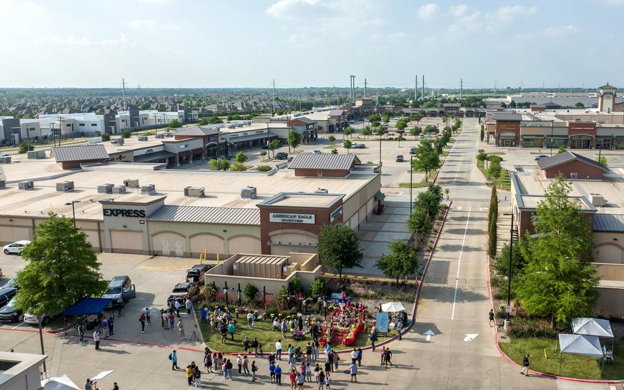 Mourners gather at the makeshift memorial in Allen, Texas. Images of the shooter firing his weapon and photos of the shooter sprawled on his back, apparently already dead, are still widely available online.