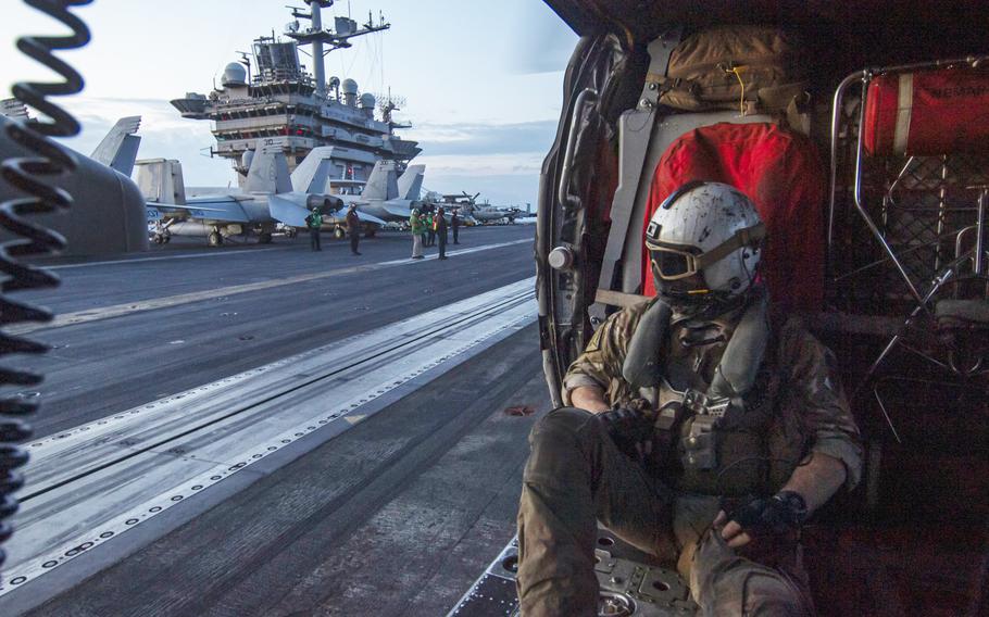 Naval Air Crewman 2nd Class Matthew Watkins, a native of Anthem, Ariz., attached to the “Dragonslayers” of Helicopter Sea Combat Squadron 11, sits in an MH-60S Sea Hawk helicopter as it prepares to launch from the flight deck of the Nimitz-class aircraft carrier USS Harry S. Truman on April 25, 2024, in the Atlantic Ocean. 