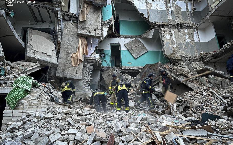 In this photo provided by the Ukrainian Emergency Services on Nov. 19, 2024, rescue workers clear the rubble of a residential building destroyed by a Russian strike in Hlukhiv, Ukraine. 