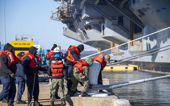 250108-N-AJ776-1060 NORFOLK, Va. (Jan. 08, 2025) Sailors heave a mooring line of the Nimitz-class aircraft carrier USS Dwight D. Eisenhower (CVN 69) at Naval Station Norfolk. Eisenhower is scheduled for Planned Incremental Availability (PIA) at Norfolk Naval Shipyard. (U.S. Navy photo by Mass Communication Specialist Seaman Evan Antonisse)