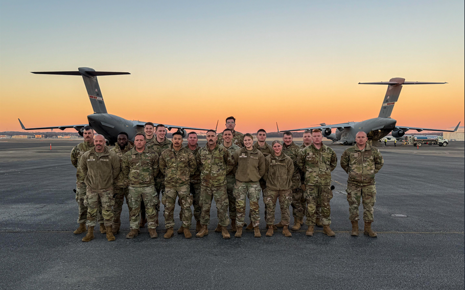 Tennessee Air National Guardsmen pose in front of a C-17 Globemaster III