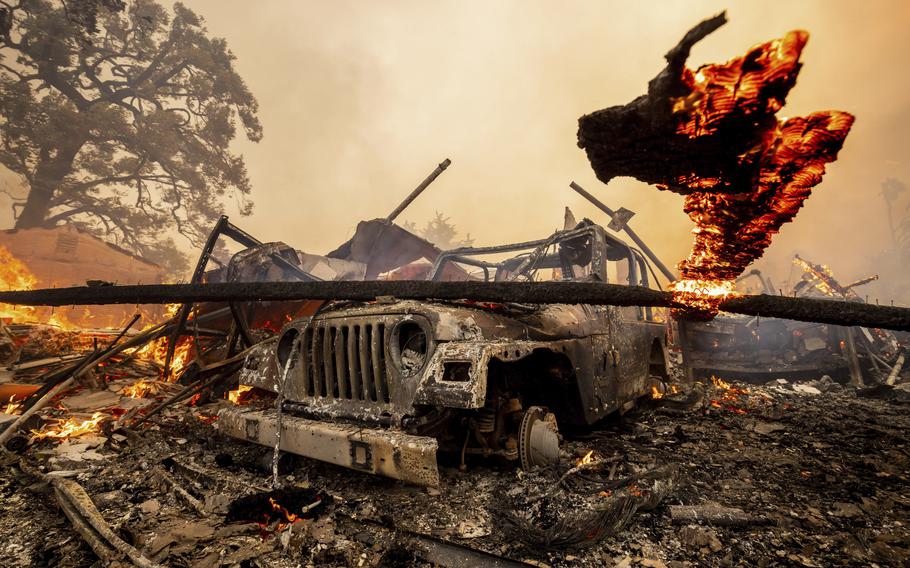 A burned vehicle in the aftermath of a wildfire in Southern California.