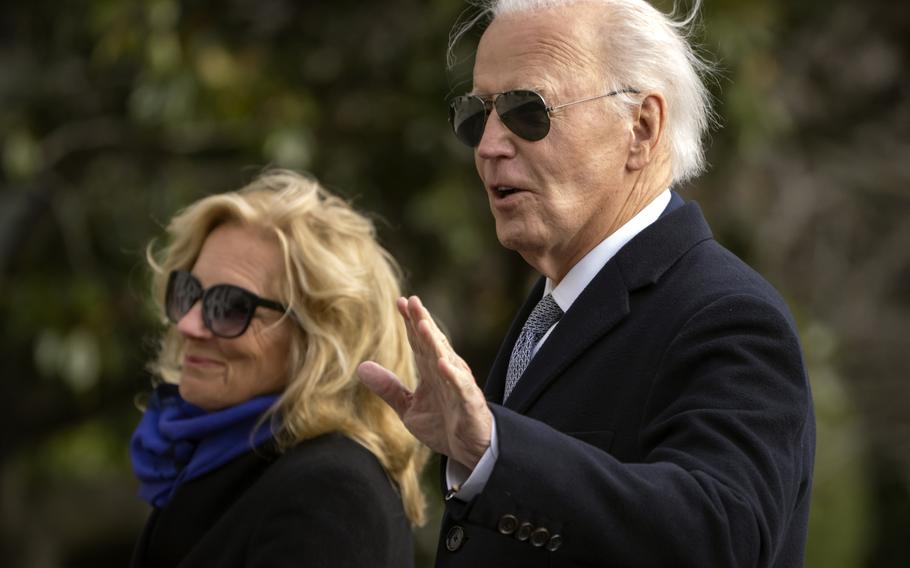 President Joe Biden gestures as he and first lady Jill Biden walk across the South Lawn of the White House, Thursday, Jan. 2, 2025, in Washington, after returning from Camp David. 