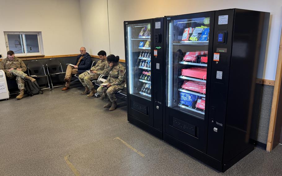 Two vending machines sit side by side at a vehicle processing center.