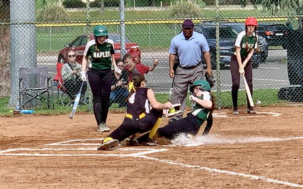 Naples' Madison Myers slides safely into home during a close play as Vicenza catcher Katherine Green tries to prevent the run. The Cougars went on to win both games of the girls' softball opening season double-header in Naples. 