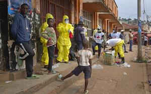 Red Cross workers gather the remains of a dead person in east Congo's second-largest city, Bukavu, one day after it was taken by M23 rebels, Monday, Feb. 17, 2025. (AP Photo/Janvier Barhahiga)