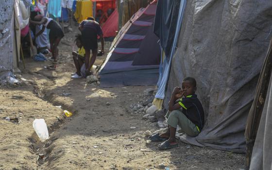 People take refuge at an abandoned school transformed into a shelter after being forced to leave their homes due to a gang attack in Port-au-Prince, Haiti, Tuesday, Oct. 29, 2024. (AP Photo/Odelyn Joseph)