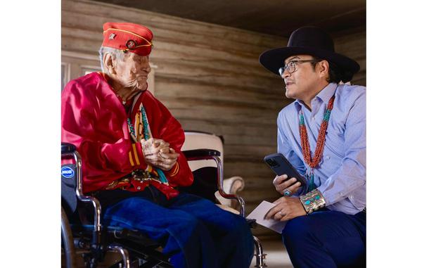 Navajo Code Talker John Kinsel Sr. talks with Navajo Nation President Buu Nygren.