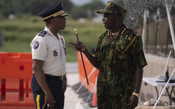 The Commander of the Multinational Security Support Mission Commander Godfrey Otunge (right) and the Haitian National Police General Director Rameau Normil speak as they wait for the arrival of US Secretary of State Antony Blinken before they met at the MSS base in Port Au Prince, Haiti on Sept. 5, 2024. Blinken is in violence-ravaged Haiti to evaluate progress in wresting control from gangs that have taken over much of the impoverished Caribbean nation. (Roberto Schmidt/Pool/AFP via Getty Images/TNS)