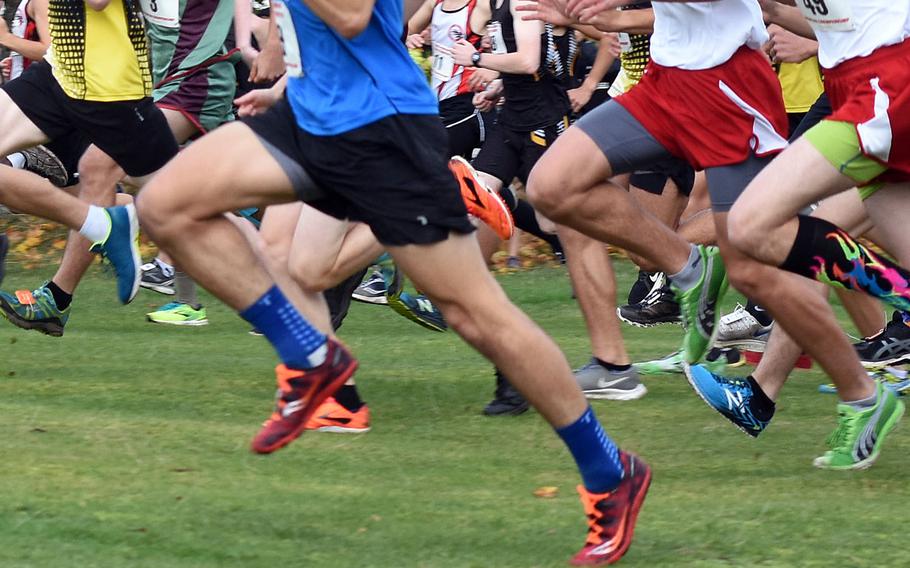 Runners start off a cross country race.