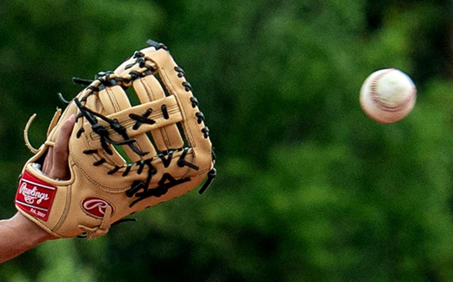 A baseball nears a glove