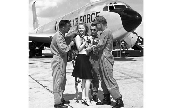 Torrejon Air Base, Spain, May, 1964: Taking no chances whatsoever, airmen on the flight line at Torrejon Air Base team up to make sure every last buckle is properly fastened on Ann-Margret's life vest. The actress, who would visit many more military facilities over the years on USO tours and become a favorite of servicemembers, was in Spain for the filming of The Pleasure Seekers, which also starred Carol Lynley and Pamela Tiffin. Her most recent release was the Elvis Presley film, Viva Las Vegas.

Looking for Stars and Stripes’ historic coverage? Subscribe to Stars and Stripes’ historic newspaper archive! We have digitized our 1948-1999 European and Pacific editions, as well as several of our WWII editions and made them available online through https://starsandstripes.newspaperarchive.com/

META TAGS: Ann-Margret; actor; celebrity; USO; U.S. Air Force; Spain; 